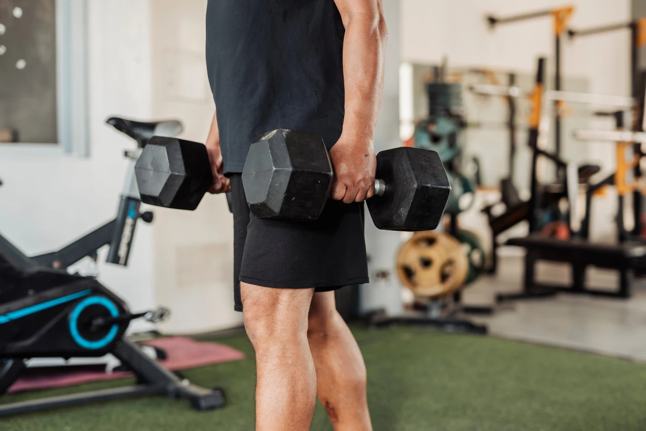 Farmers Walk with dumbbells Man performing a Farmers Walk with dumbbells