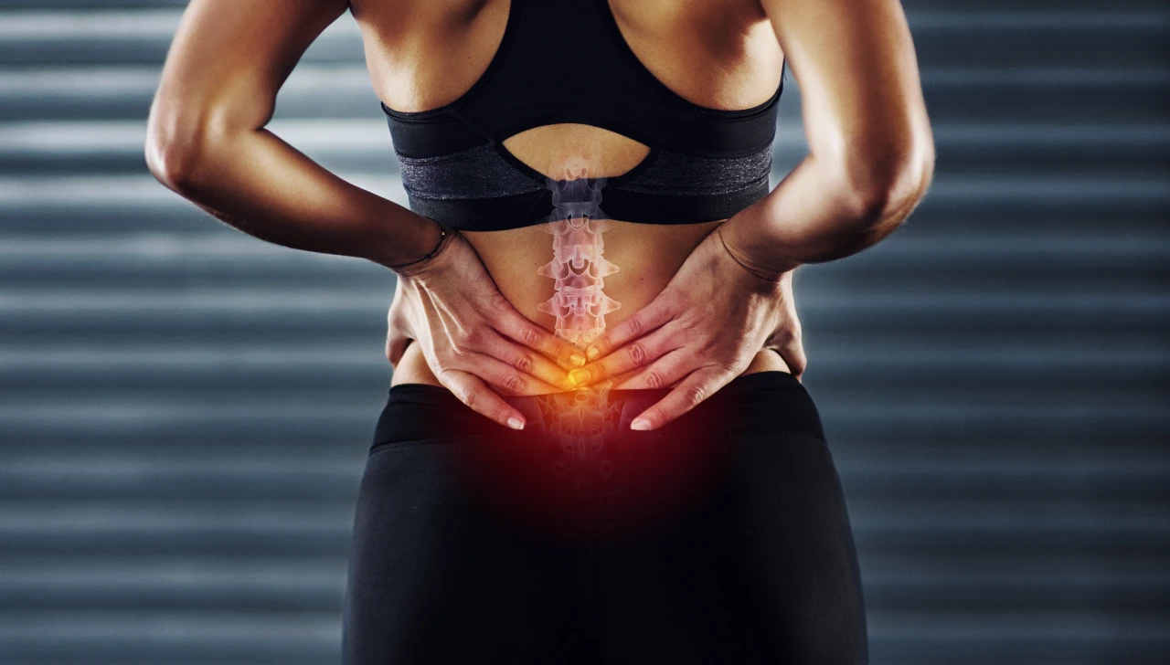 Woman experiencing lower back pain in the lumbar spine